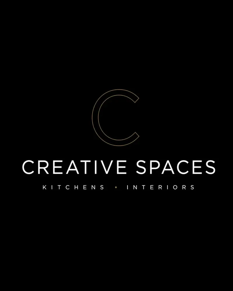 Creative Spaces logo: a thin gold C above the Creative Spaces name and 'Kitchens · Interiors' in ivory on black